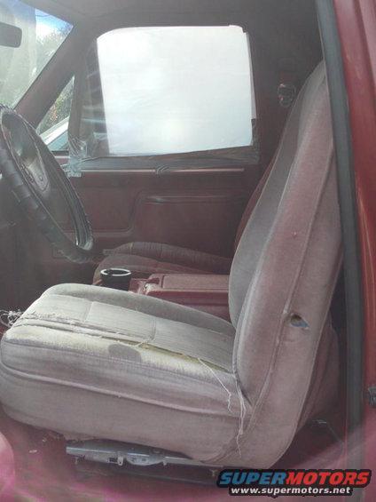 Interior of a 1988 Ford Bronco showing worn driver's seat and dashboard