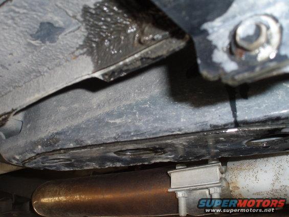 Exhaust pipe with clamp, undercarriage, and fluid leak