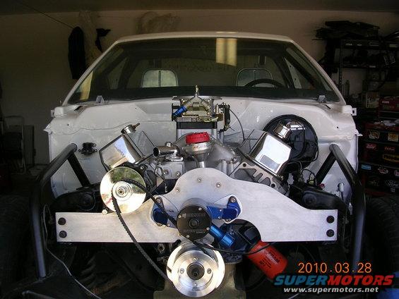 Engine bay with V8 engine, chrome valve covers, and custom intake