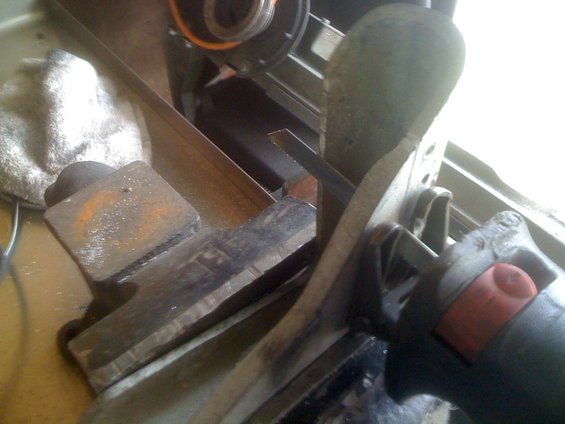 Trolling motor part with red trigger, metal blade, and cloth
