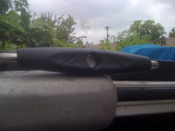 Close-up of a black boat trolling motor handle with a silver shaft