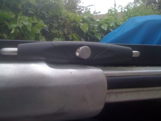 Close-up of a black and silver boat cleat with a silver knob
