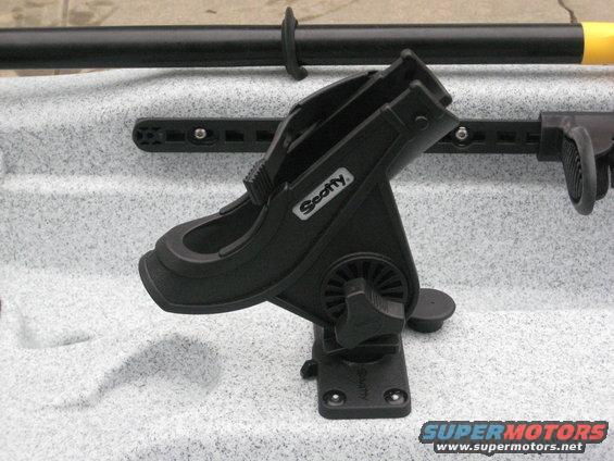 Kayak with a Scotty brand rod holder attached. A paddle is also visible