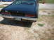 1970 Ford Falcon - The rear of a black 1970 Ford Falcon is shown, parked on a gravel surface.