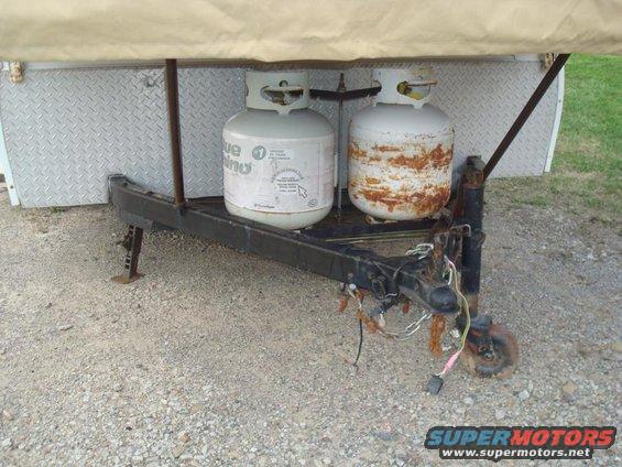 Two propane tanks on a trailer hitch, one rusted