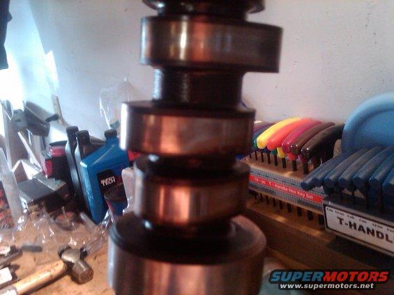 Camshaft with bearings and tool set in background