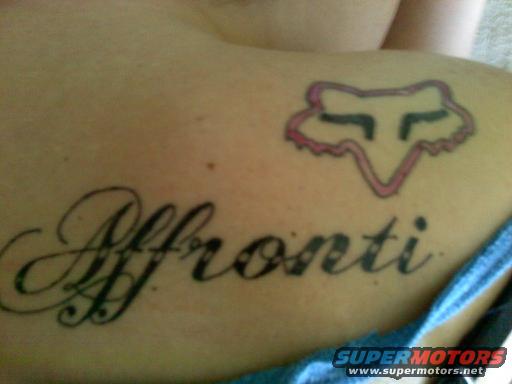 Tattoo of the name 'Affronti' and a pink fox head logo on skin
