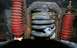 1979 Ford Bronco - Underside view of vehicle suspension system, showing coil springs and shock absorbers.