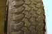 1979 Ford Bronco - The image shows a detailed view of an off-road tire's aggressive tread pattern, with some text visible on the sidewall.