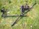 1985 Toyota Pickup/SR5 - Steering rack and tie rod assembly, likely for a truck, lying on a grassy surface.