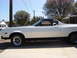 1973 Ford Ranchero - A white 1972 Ford Ranchero is parked on a concrete driveway under a clear blue sky.