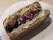 1990 Ford Bronco - A close-up view of a loaded hot dog on a paper plate, showing its various toppings.