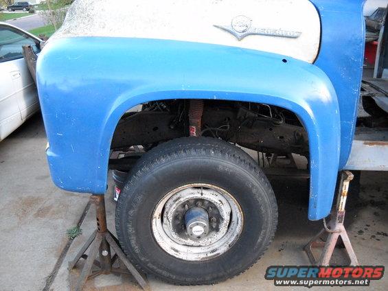 54-build--41610-060.jpg Today I dug out the F600 front fenders and all the other front clip parts I'll be using. After I got all the parts dug out I started bolting the parts on.

I started out bolting the back side of each fender to the cab while the front of the fenders were supported by a jack stand. Next I bolted in the hood latch panel. Then I bolted in the air deflectors and radiator mount as an assembly. The air deflectors are sitting right on the top of the frame. This means the cab is going to need to sit even higher. It was also pretty obvious just by looking at the front fenders that the cab would have to be moved farther forward. I did some measureing and it looks like I will be raising the cab 2" higher ( and leveling it ). And I will be moving it 2" forward. My firewal recess is going to be tight but I think it will work. The cab be lifted a little more is going to give me a little more clearance. Oh yea I also sat the 56 F250 hood.