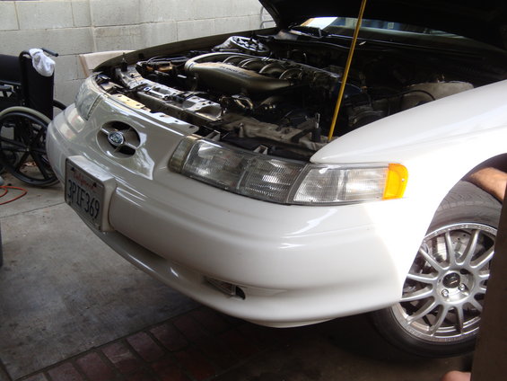 White 1995 Ford Taurus front view, hood open. California license plate 3PIF369