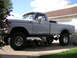 1979 Ford F-250 - This lifted 1979 Ford F-250 pickup truck is parked in a driveway with a garage in the background.