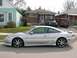 1994 Mazda MX-6 - A silver coupe is parked on the street in front of houses, with a truck and van visible.