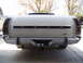 1973 Ford Ranchero - The rear of a light-colored Ford Ranchero pickup truck is shown, a chrome bumper and the Ford logo.