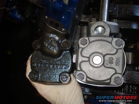 Two oil pumps, one old and greasy, the other new and clean, are compared side-by-side
