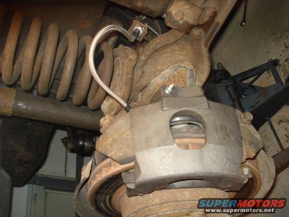 Brake caliper and rusty coil spring assembly