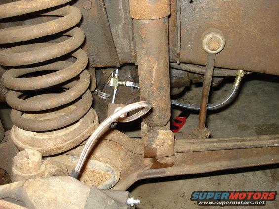 Rear suspension with brake lines and shock absorber