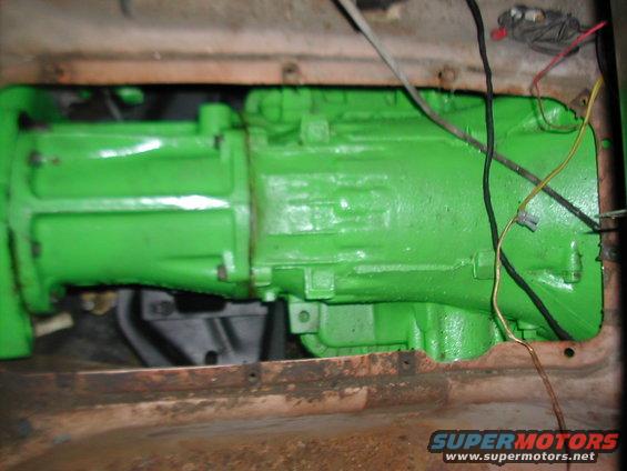 Close-up of a green painted transmission with wires attached