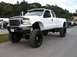 1994 Ford Bronco - This lifted 2002 Ford F-350 Super Duty truck features oversized tires and a prominent grille.