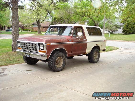 Red and white 1979 Ford Bronco parked on a driveway
