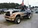 1994 Ford Bronco - This customized SUV is on display with its hood open, custom paint and off-road tires.