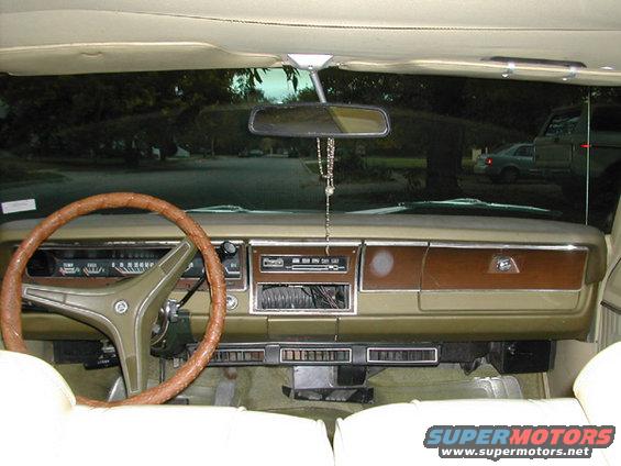 1971 Dodge Dart interior, tan dashboard with wood grain trim, brown steering wheel, and white seats