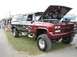 1994 Ford Bronco - This custom pickup truck features a two-tone paint job and a lifted suspension.