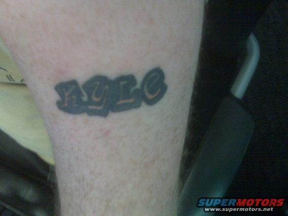 Tattoo with graffiti-style lettering on a person's arm