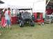 1994 Ford Bronco - A modified golf cart with oversized tires sits on display outdoors near a trailer and a tent.