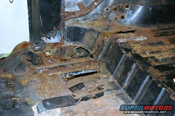 rusted interior floor pan with holes and exposed metal