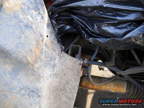 54-build--41910-050.jpg The little problem with the passenger side is an aftermarket steering stabilizer bracket. I just pried the inner fender panel out out to clear it for now.