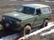 1989 Ford Bronco - This modified Ford Bronco navigates a challenging muddy and snowy terrain.
