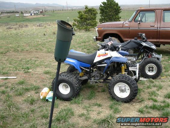 1995 Yamaha BLASTER parked next to another ATV, with a brown pickup truck behind them