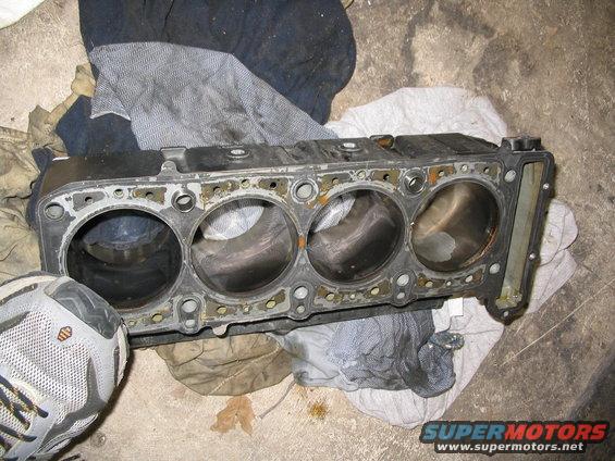 Engine cylinder block with four cylinders, resting on cloth