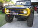 1973 Ford Bronco - This 1973 Ford Bronco is equipped with a winch and off-road tires, parked in a driveway.
