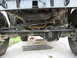 1973 Ford Bronco - This photo shows the undercarriage of a 4x4 vehicle, focusing on the suspension and drivetrain components.