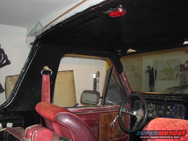 1981 Ford Bronco interior with red seats and black dashboard