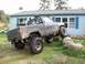 1985 Toyota Pickup/SR5 - Modified 1985 Toyota Pickup/SR5 with lifted suspension and large tires is shown off-road.