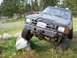 1985 Toyota Pickup/SR5 - This modified Toyota pickup truck is shown off-road with its front tire resting on a large rock.