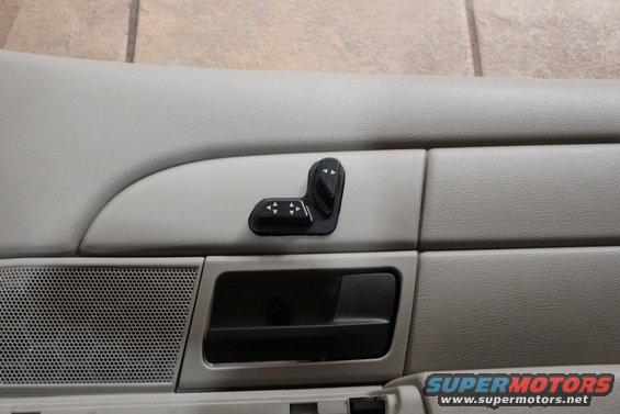 Interior door panel with power seat controls and speaker grille