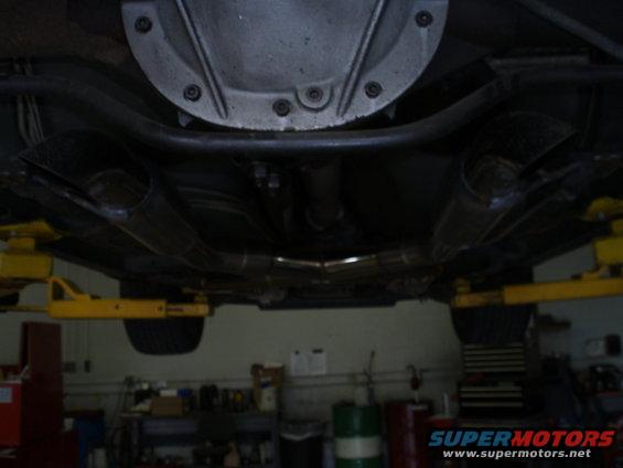 Underbody view of dual exhaust pipes and differential