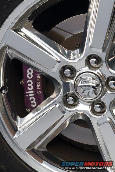 Chrome wheel with purple Wilwood 6 piston brake caliper and Mercury emblem center cap