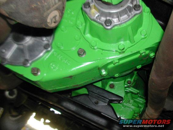 Green painted transmission housing with bolts and metal components