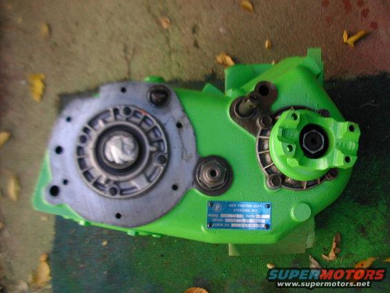 Green New Process Gear transfer case with a blue data plate. It's sitting on the ground