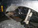 1984 Ford Bronco II - Close-up view of a vehicle's modified suspension system, hydraulic lines and dual shock absorbers.
