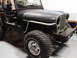 1979 Jeep CJ7 - A black Jeep CJ with a light blue hood and off-road tires is shown from the front three-quarter view.