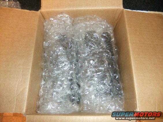 Two parts wrapped in bubble wrap inside a cardboard box